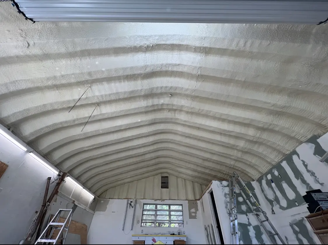 Spray polyurethane foam applied to the underside of a metal roof deck in Sanford